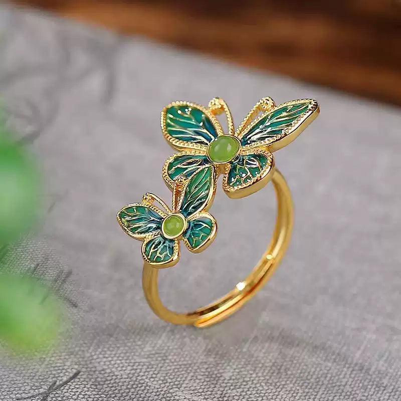 Adjustable double butterfly ring with green detailing, front view