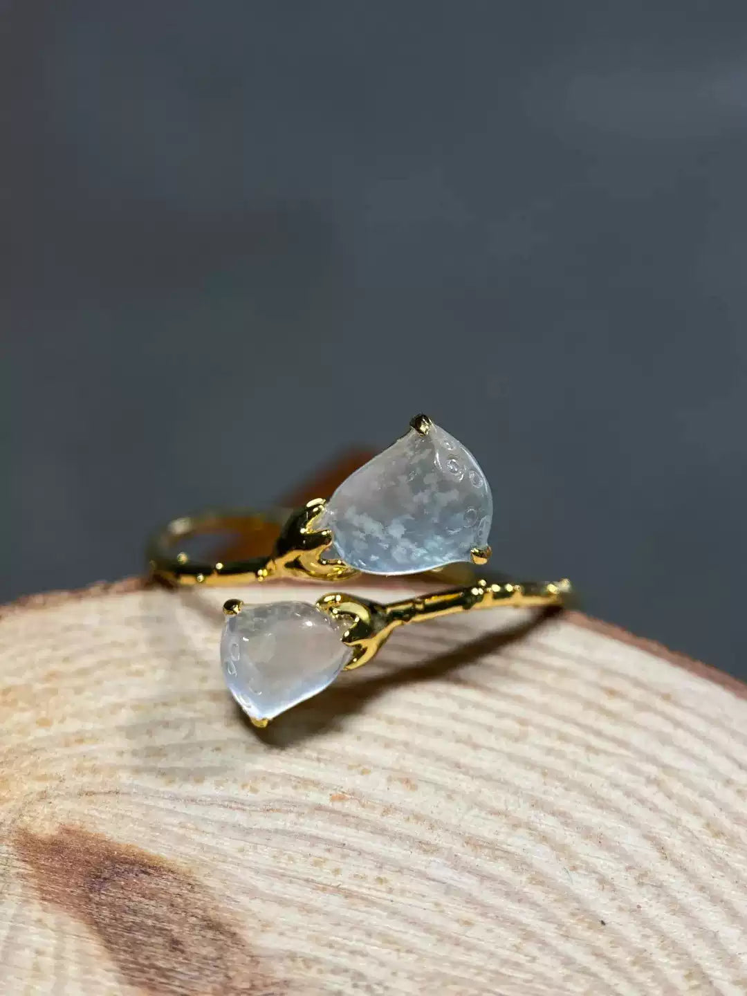 Double lotus pod ring displayed on a natural wood surface