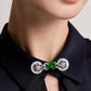 Close-up of the green faux-jade center and pale circular details on the collar brooch