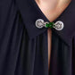 Front view of a green faux-jade collar brooch fastening two shirt collar points