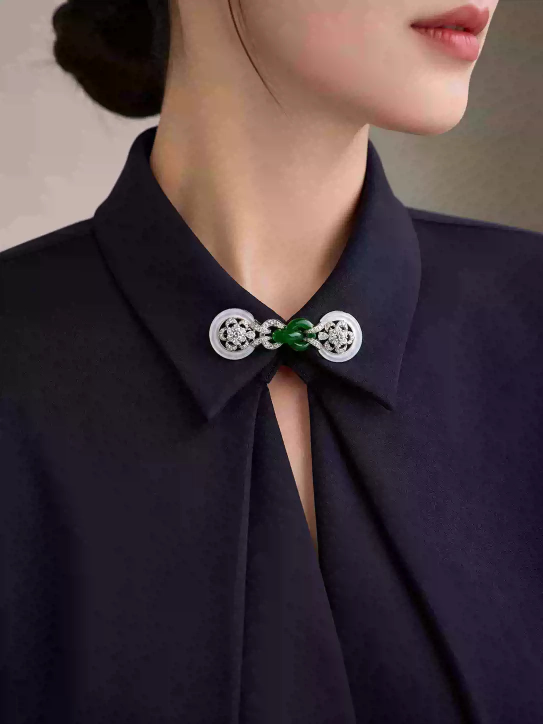 Collar brooch with a green faux-jade centerpiece styled on a black collared shirt