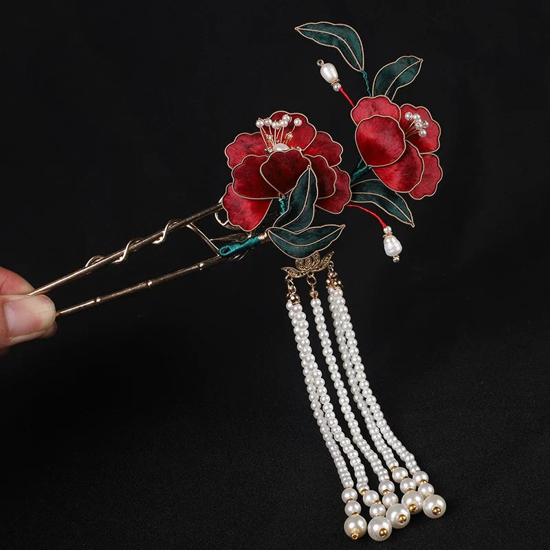 Burgundy floral U-shaped hairpin with a white beaded tassel