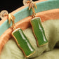 Close-up of the green bamboo segment earrings showing their gold-plated bamboo tops