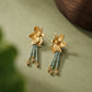 Close-up of the engraved flower fronts and green bead tassels