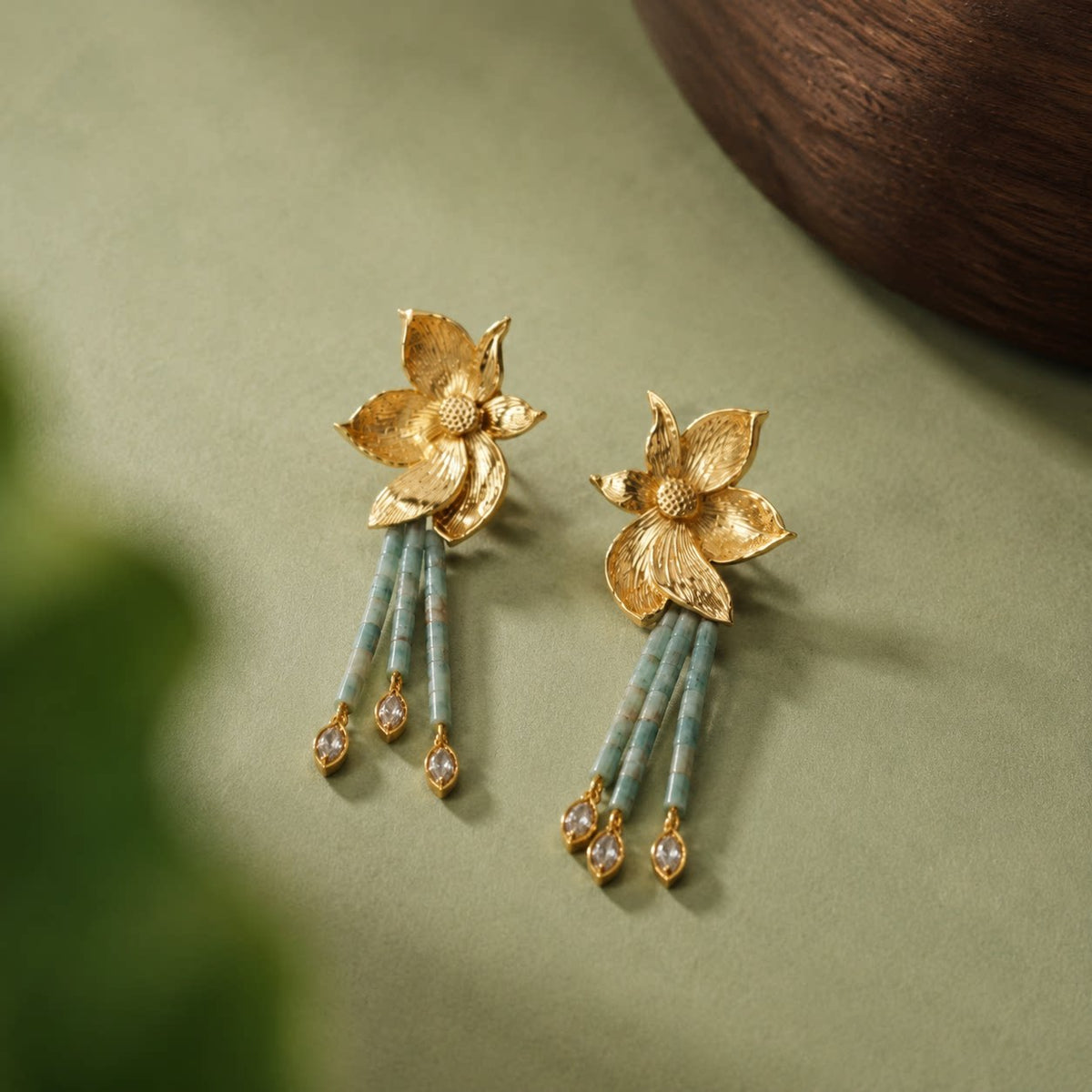 Close-up of the engraved flower fronts and green bead tassels