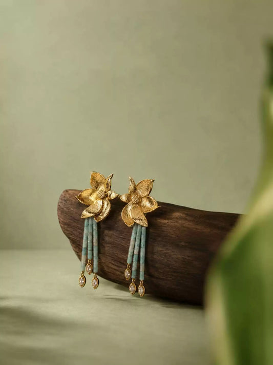 Pair of gold-tone floral stud earrings with pale green bead tassels and clear teardrop accents
