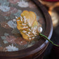 Full view of the ginkgo leaf floral brooch displayed upright