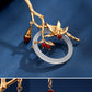 Gold bamboo orchid hairpin detail with red beads and circular ornament