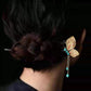 Gold butterfly hairpin styled in a hair bun