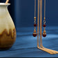 Gold chain tassel and red bead detail