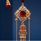 Gold filigree tassel pendant detail with red bead