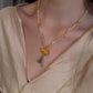 Gold-tone gourd pendant necklace with layered strands and bead accents
