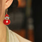 Red gourd drop earring worn, showing the turquoise floral connector