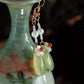 Close view of pearl, white shell flower and pale green agate drop