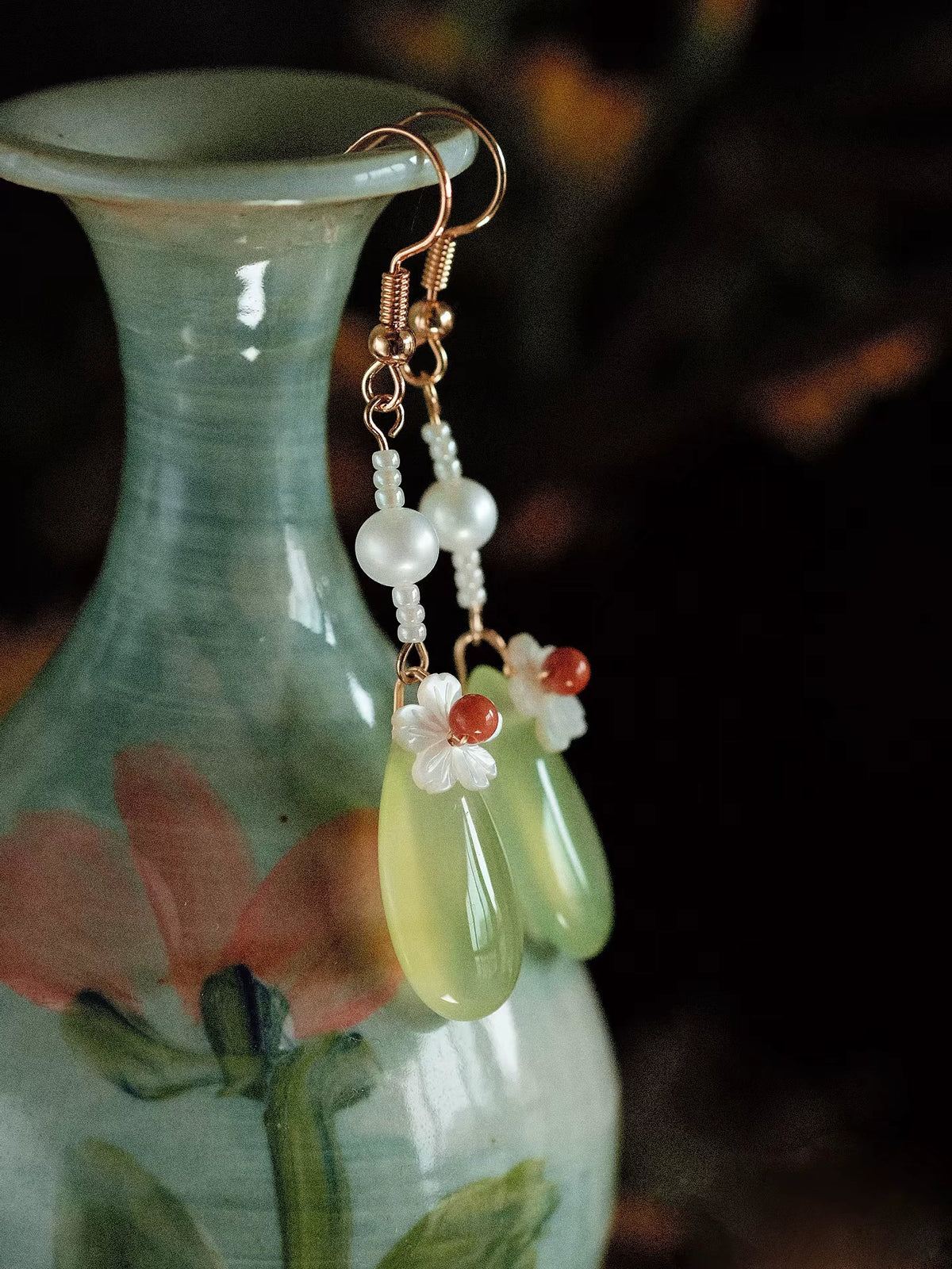 Close view of pearl, white shell flower and pale green agate drop