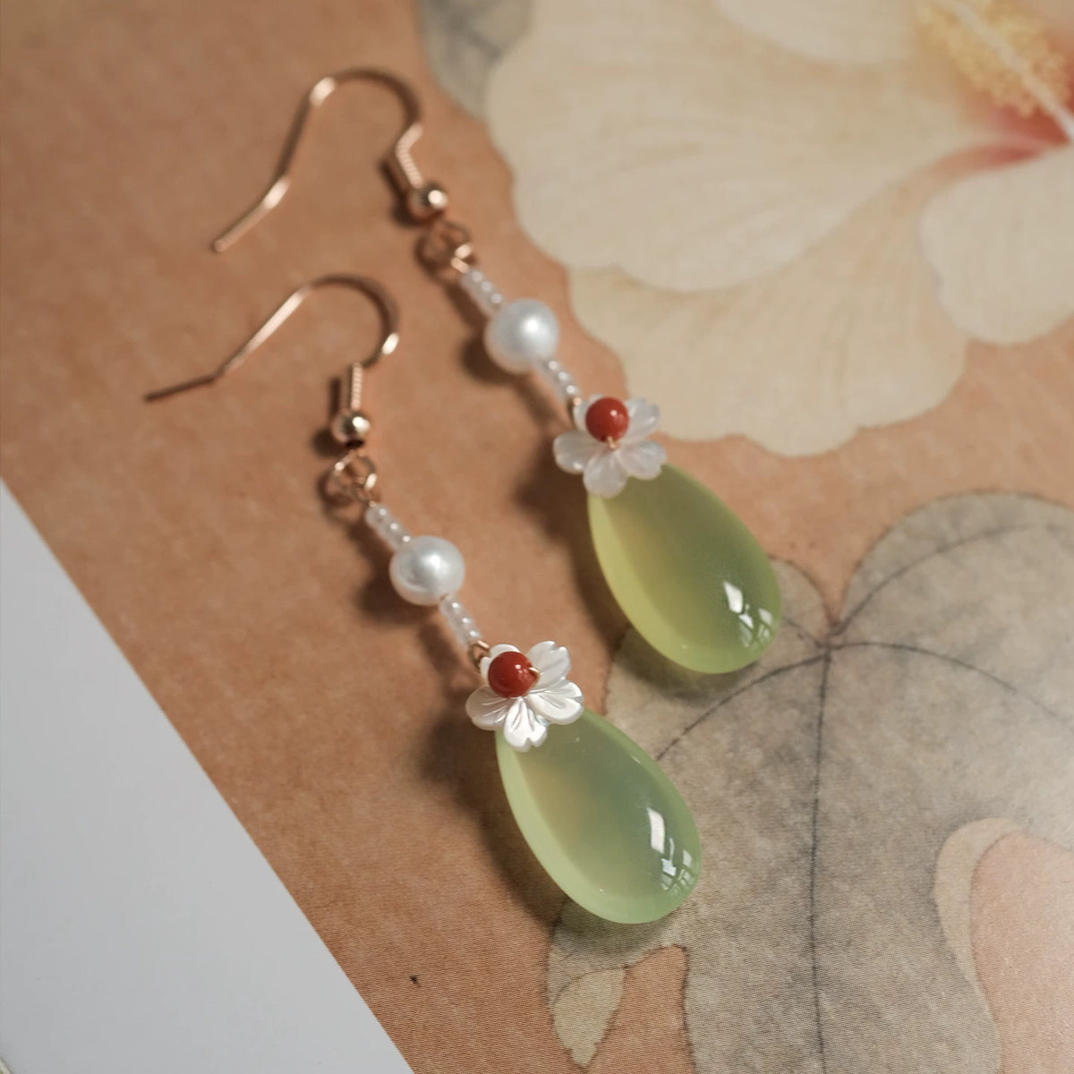 Pair of green agate earrings with white mother-of-pearl flowers and red agate accents