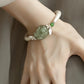 Green faux jade-style peony and butterfly copper cuff bracelet, front view