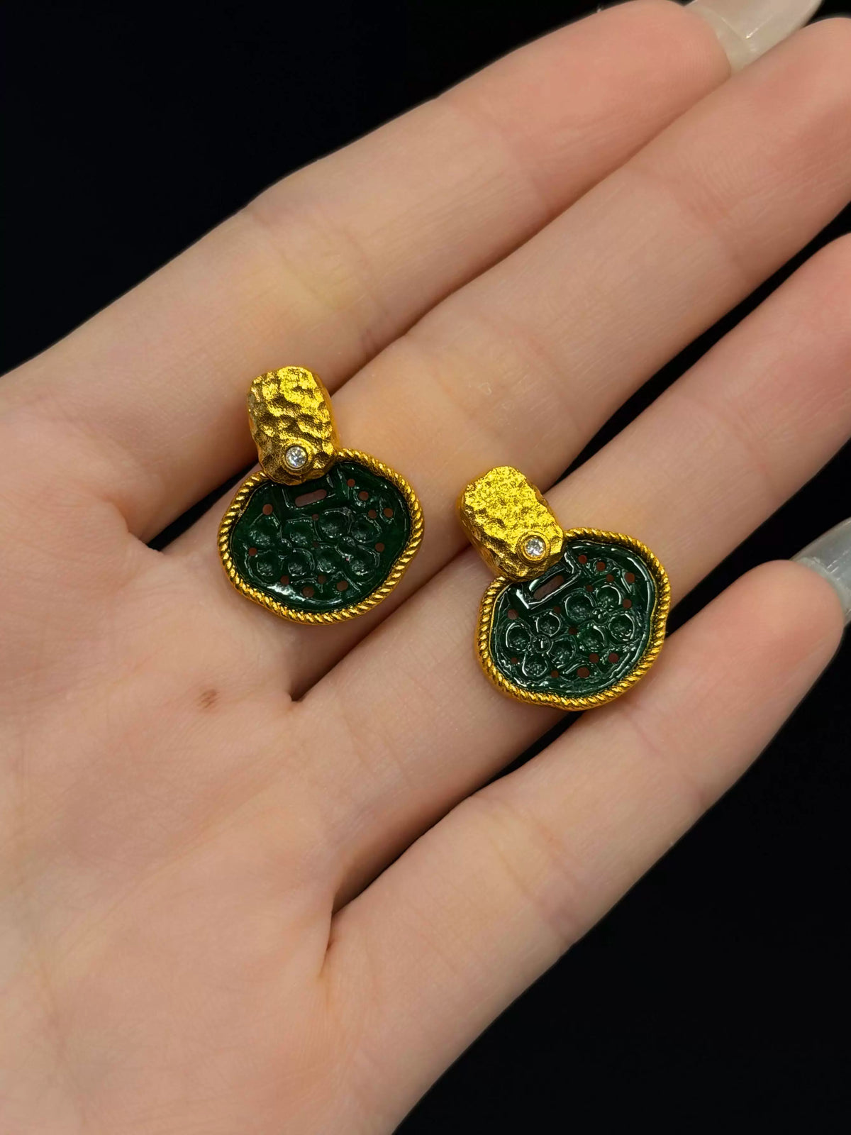 Front detail of the green and gold-tone garden-window stud earrings