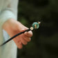 Hand-held view of the dark hair stick and lotus-leaf ornament