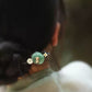 Back view of the green lotus-leaf hairpin worn in an updo