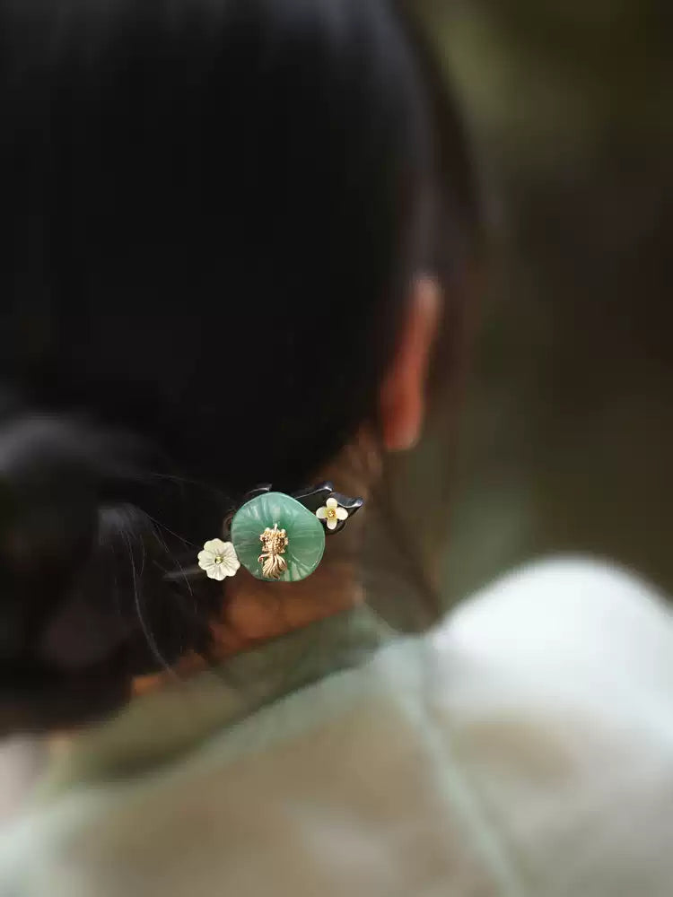 Back view of the green lotus-leaf hairpin worn in an updo