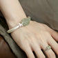 Second wrist view of the green peony and butterfly cuff bracelet
