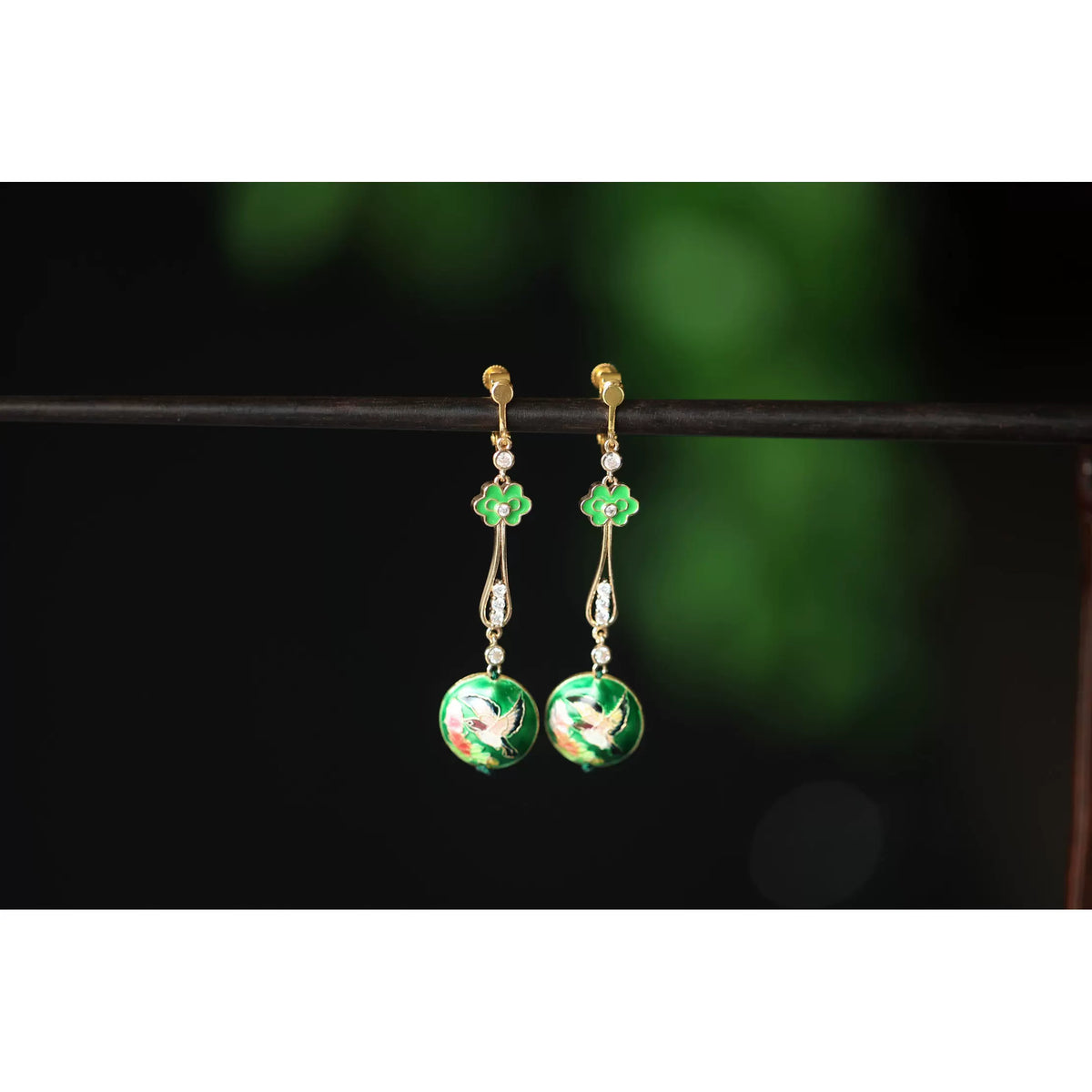 Close-up rear view of the green floral earrings and fastening components