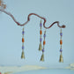 Alternate display of the long bell earrings on a branch