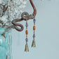 Bell-shaped charms and purple beads on Hua Ling dangle earrings