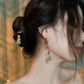 Purple bead bell earring styled with a warm-toned outfit