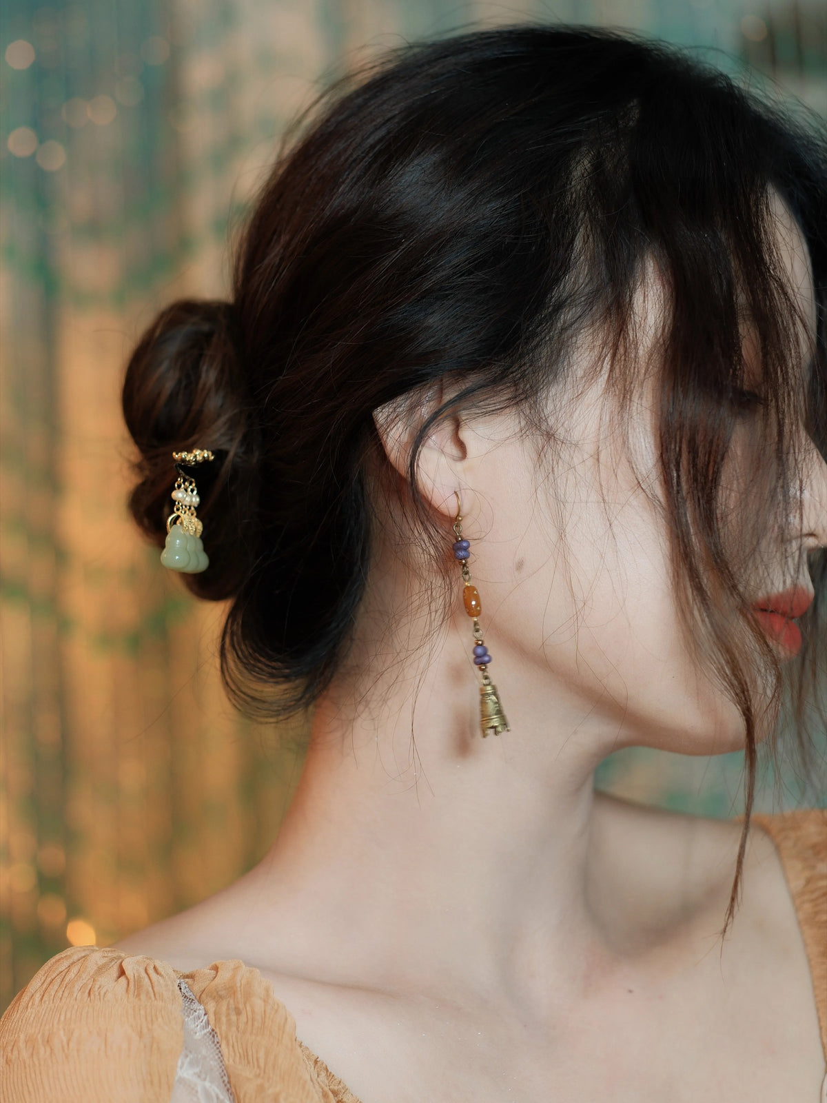Purple bead bell earring styled with a warm-toned outfit