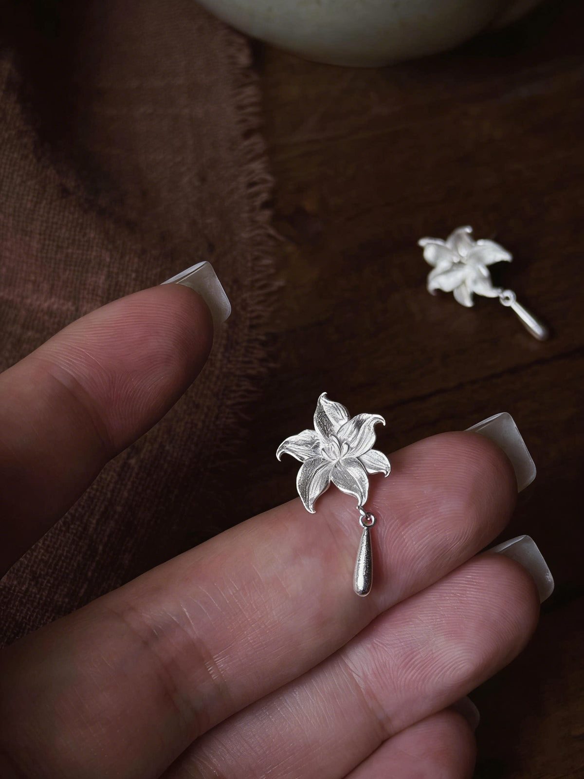 Close-up view of a lily flower earring and its post backing