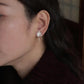 Lily flower drop stud earring shown worn on the ear