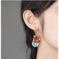 Profile view of the koi fish earring worn on the ear