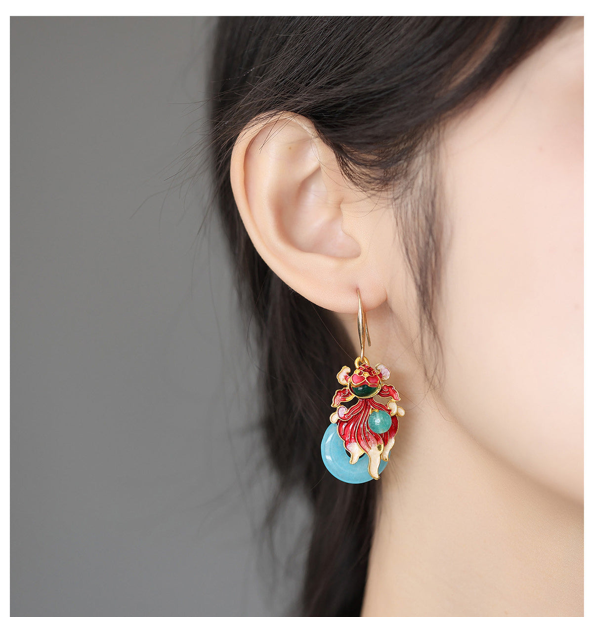 Profile view of the koi fish earring worn on the ear