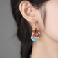 Close-up of a koi fish earring worn on the ear