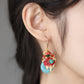 Koi fish drop earring shown worn from the side