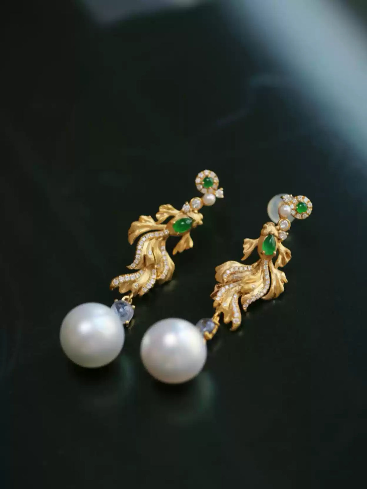 Pair of koi fish drop earrings showing the stud posts and dangling white round accents