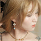 Lian Yi lotus earring worn with short hair, hook style