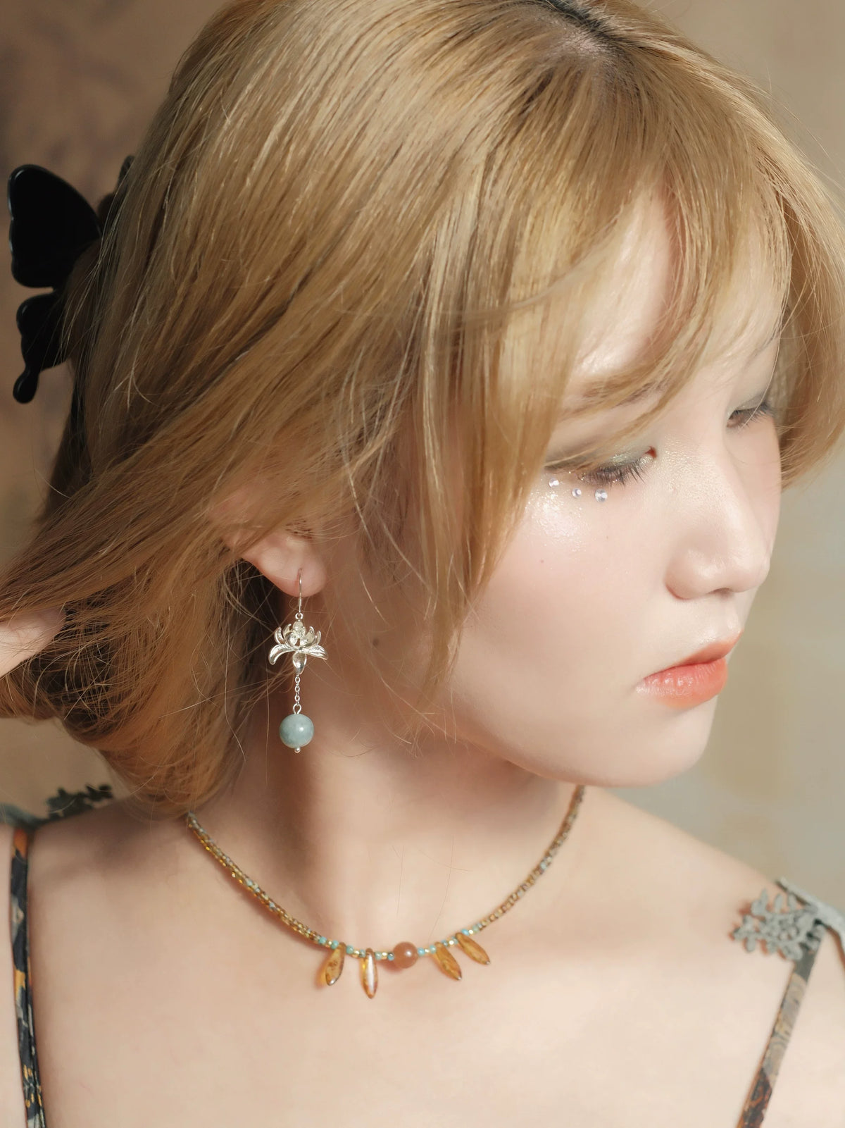 Lian Yi lotus earring worn with short hair, hook style