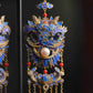 Close-up of the blue lion motif and dangling chain details