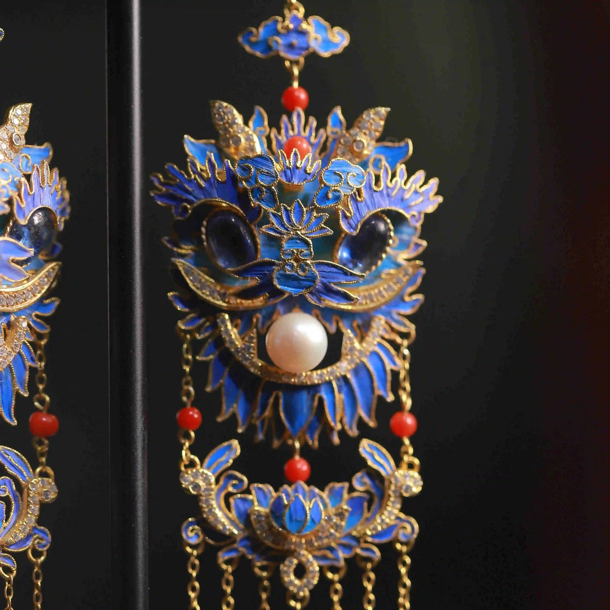 Close-up of the blue lion motif and dangling chain details