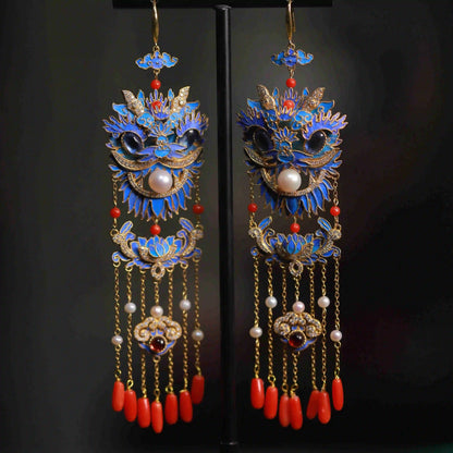Blue lion-dance mask earrings with gold-tone outlines and red tassel accents