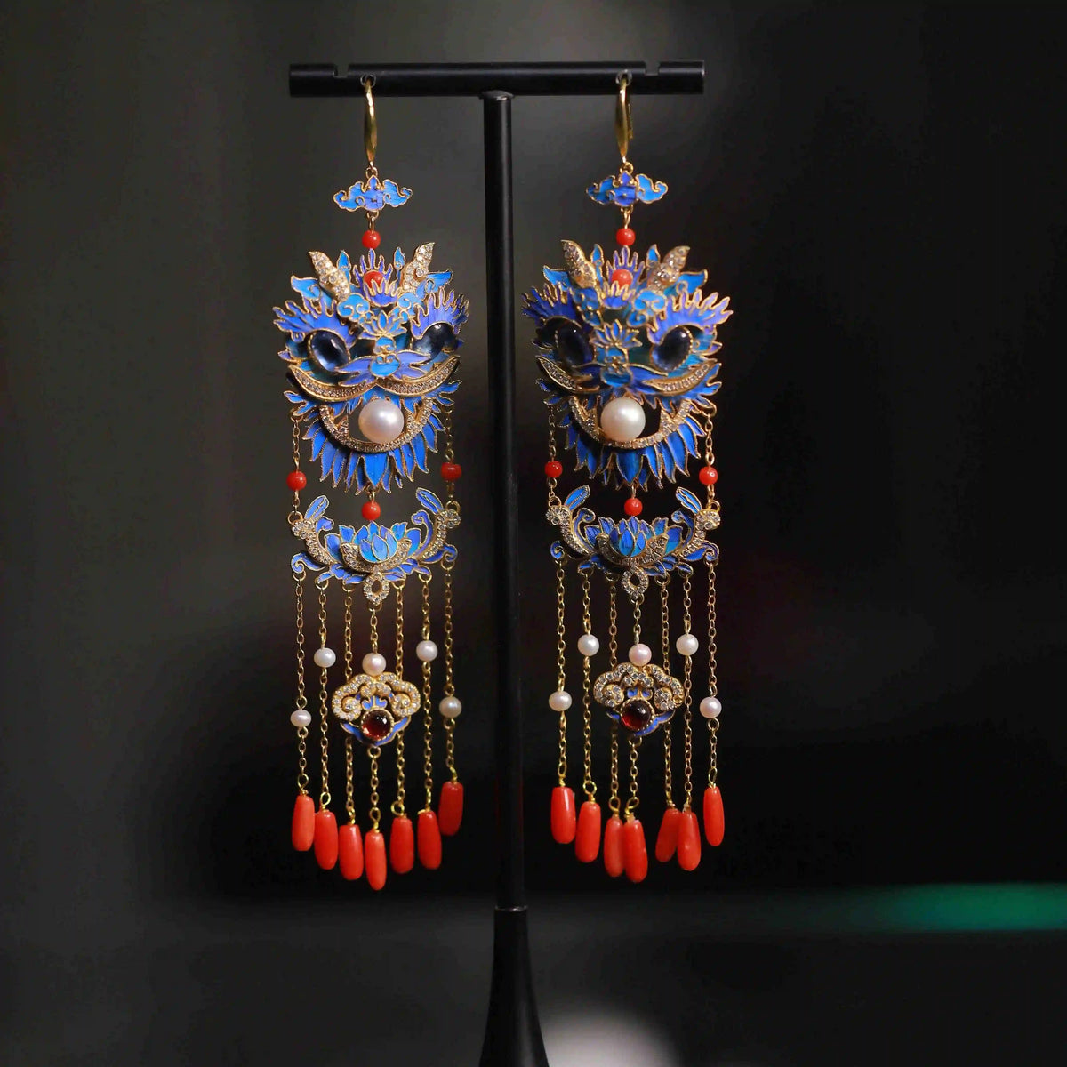 Full-length view of the lion-dance earrings with long chain tassels