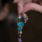 Long blue and purple lotus drop earrings with circular motifs