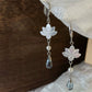 Iridescent shell lotus petals with blue-gray glass teardrop pendants