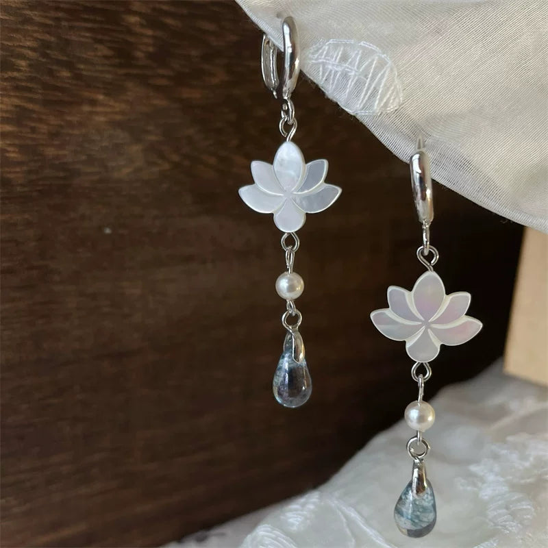 Iridescent shell lotus petals with blue-gray glass teardrop pendants