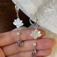 Close-up of white mother-of-pearl lotus flowers and glass teardrops