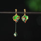 Green koi earrings with gold-tone clip-on fastening