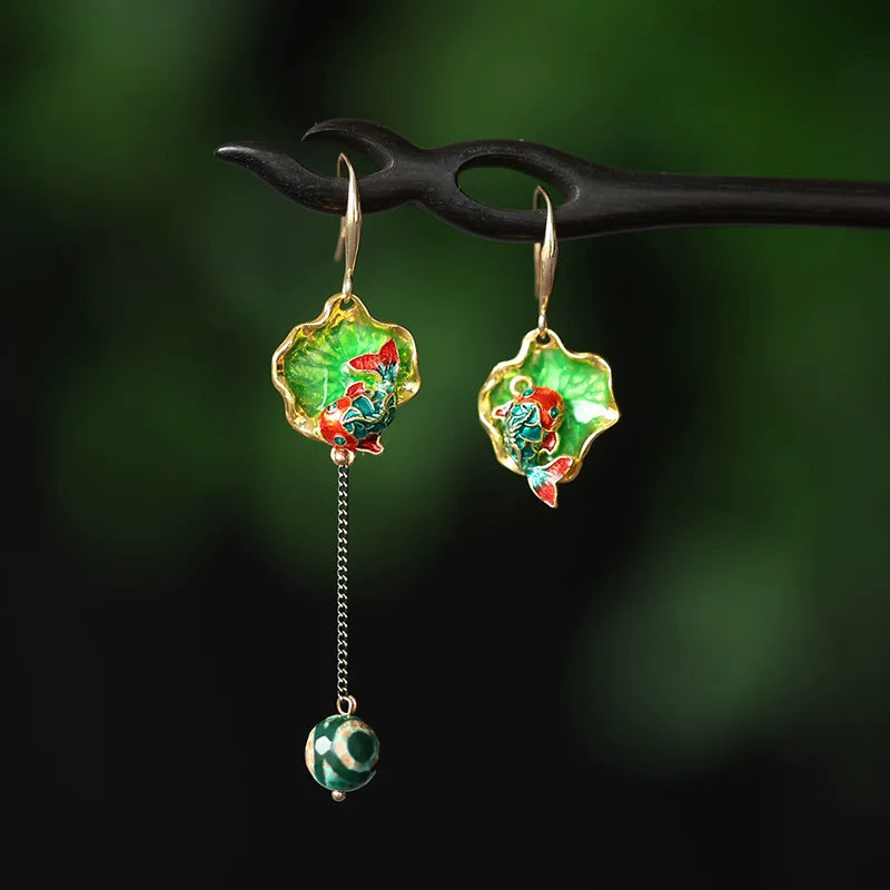 Asymmetric green koi and lotus pond drop earrings with a long dangling bead